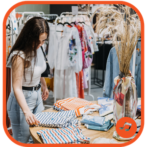 Relaxed customer shopping for clothes, listening to background music in the store